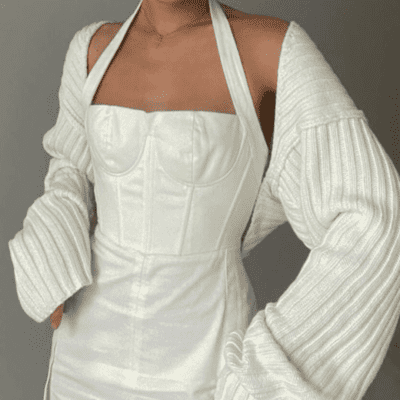 White corset dress with knitted cardigan.